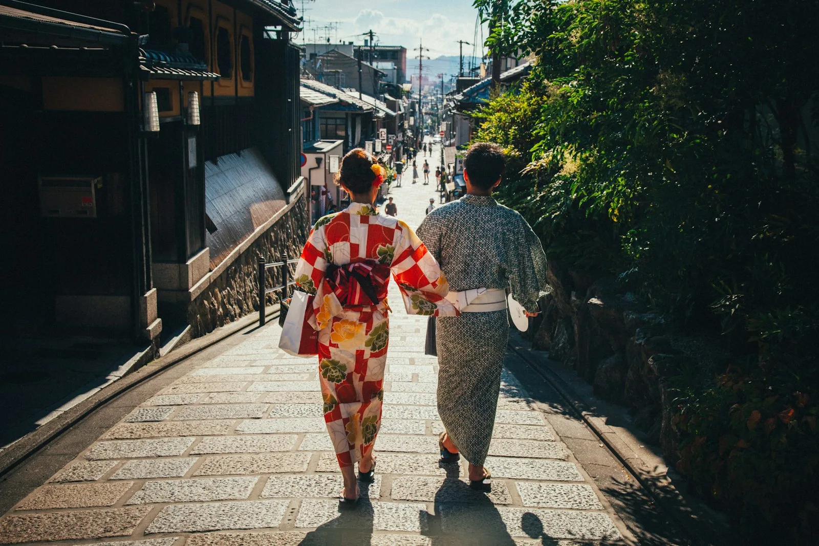 A couple in yukata walking an old lane